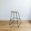 kitchen stool with black wire legs & handsanded round oak seat