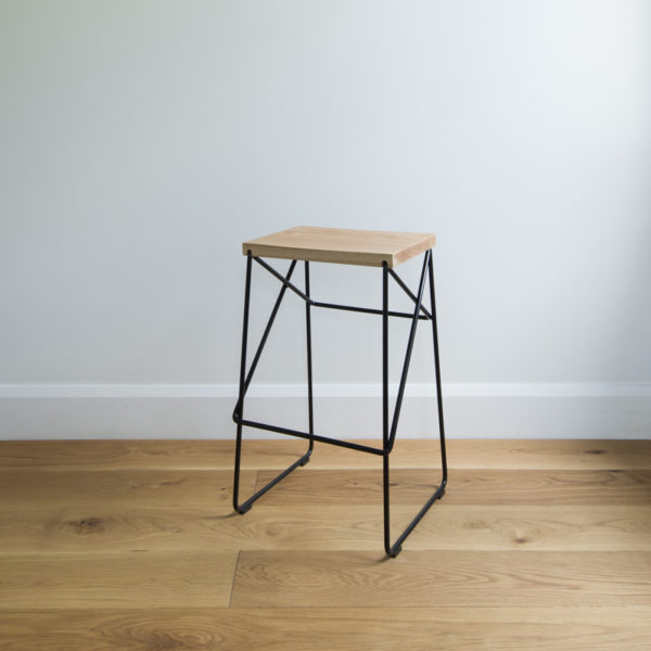 angle view of black wire kitchen stool with criss cross legs & solid oak seat