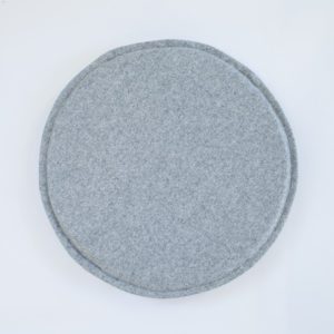 A grey, felted wool, round circle chair or stool pad / cushion