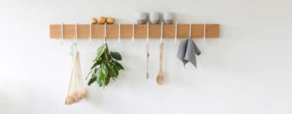 Sustainably grown solid white Oak shelf with white metal S hooks to hang items from it.
