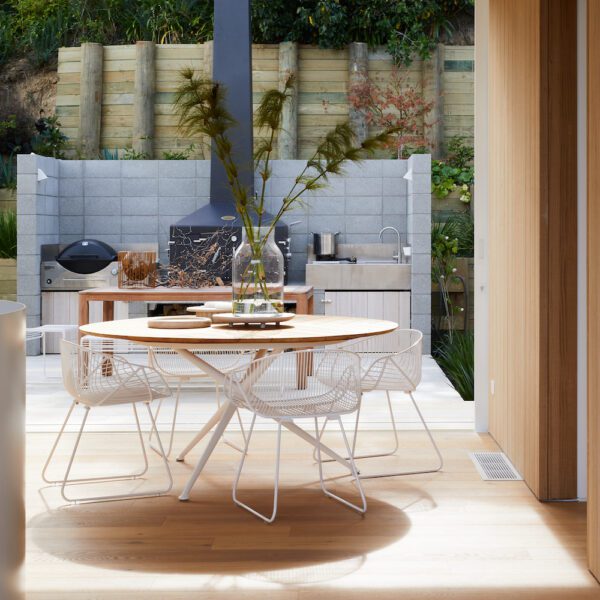 Modern Portobello dining chair with curved armrests and low backrest, ideal for indoor or commercial use.