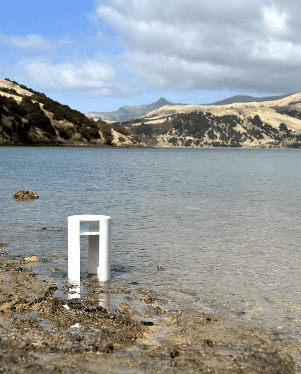 “Coastal seaside with Waipuna stainless steel side table and ocean horizon view”