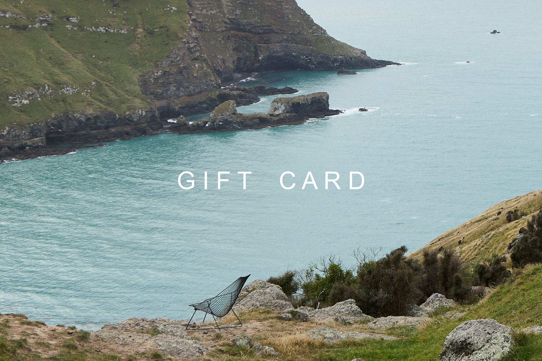 Ico Traders Gift Card featuring the Piha Lounger overlooking the New Zealand coastline.